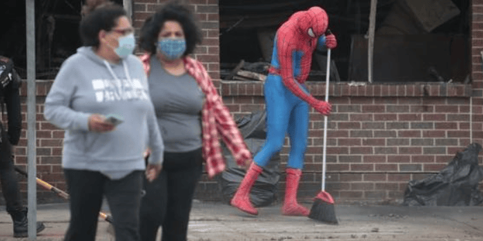 Spider Man cleans up the rubble after a protest for George Floyd